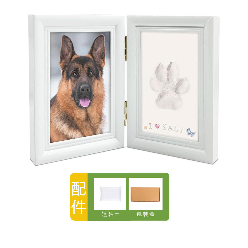 DIY hollow photo frame with baby's 100-day and first birthday hand and footprints, pet paw prints, and baby hand and footprint clay keepsakes.