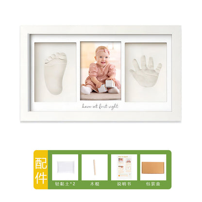 DIY hollow photo frame with baby's 100-day and first birthday hand and footprints, pet paw prints, and baby hand and footprint clay keepsakes.