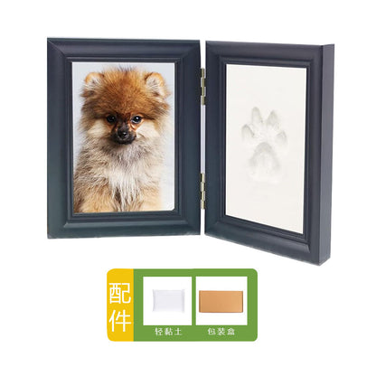 DIY hollow photo frame with baby's 100-day and first birthday hand and footprints, pet paw prints, and baby hand and footprint clay keepsakes.
