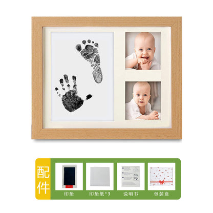 DIY hollow photo frame with baby's 100-day and first birthday hand and footprints, pet paw prints, and baby hand and footprint clay keepsakes.