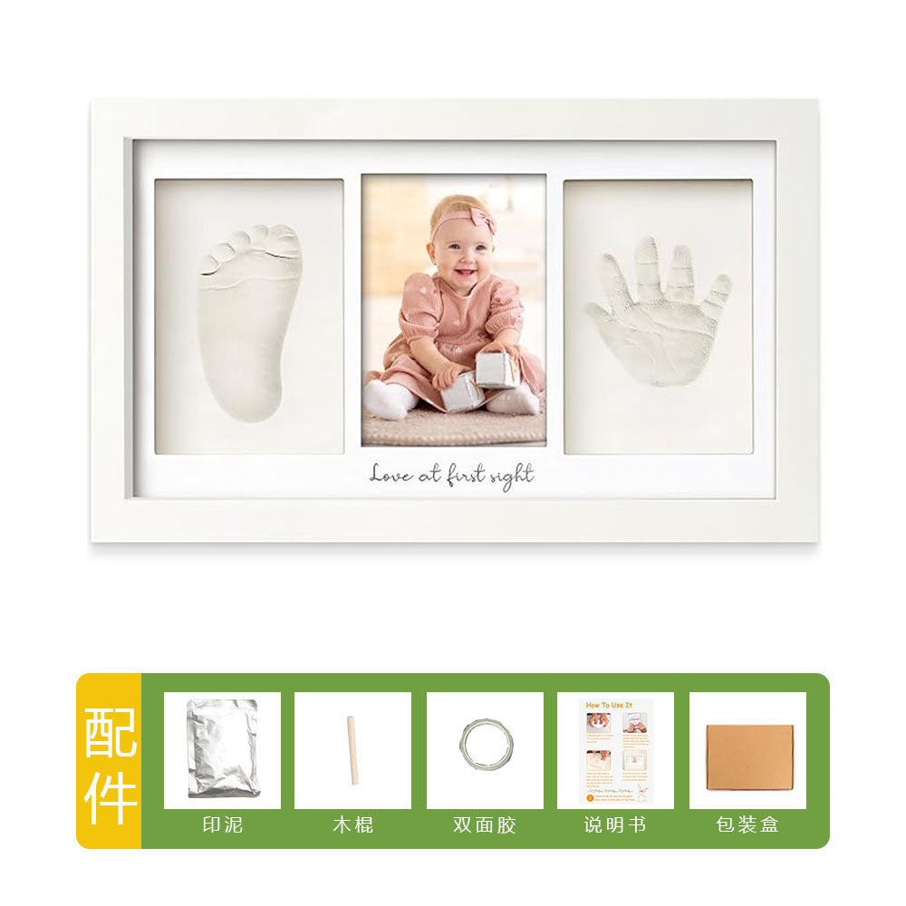 DIY hollow photo frame with baby's 100-day and first birthday hand and footprints, pet paw prints, and baby hand and footprint clay keepsakes.