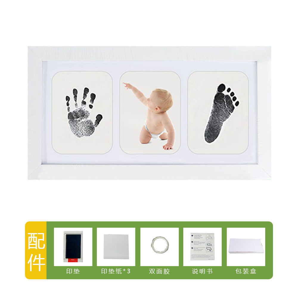 DIY hollow photo frame with baby's 100-day and first birthday hand and footprints, pet paw prints, and baby hand and footprint clay keepsakes.