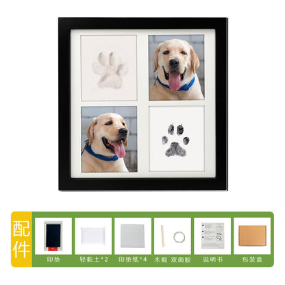 DIY hollow photo frame with baby's 100-day and first birthday hand and footprints, pet paw prints, and baby hand and footprint clay keepsakes.