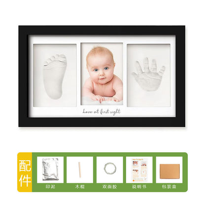 DIY hollow photo frame with baby's 100-day and first birthday hand and footprints, pet paw prints, and baby hand and footprint clay keepsakes.