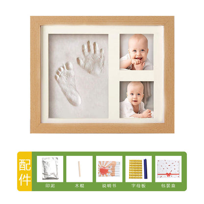 DIY hollow photo frame with baby's 100-day and first birthday hand and footprints, pet paw prints, and baby hand and footprint clay keepsakes.