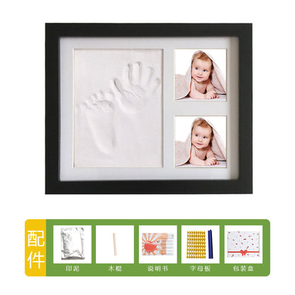 DIY hollow photo frame with baby's 100-day and first birthday hand and footprints, pet paw prints, and baby hand and footprint clay keepsakes.