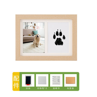 DIY hollow photo frame with baby's 100-day and first birthday hand and footprints, pet paw prints, and baby hand and footprint clay keepsakes.
