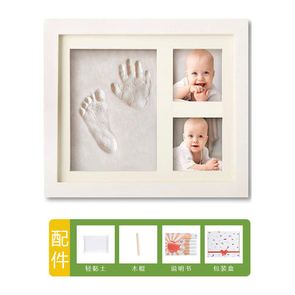 DIY hollow photo frame with baby's 100-day and first birthday hand and footprints, pet paw prints, and baby hand and footprint clay keepsakes.