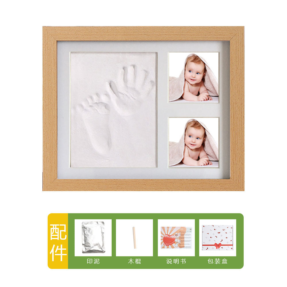 DIY hollow photo frame with baby's 100-day and first birthday hand and footprints, pet paw prints, and baby hand and footprint clay keepsakes.