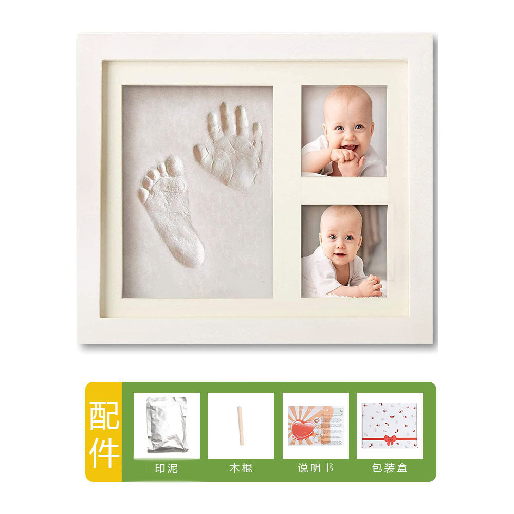 DIY hollow photo frame with baby's 100-day and first birthday hand and footprints, pet paw prints, and baby hand and footprint clay keepsakes.