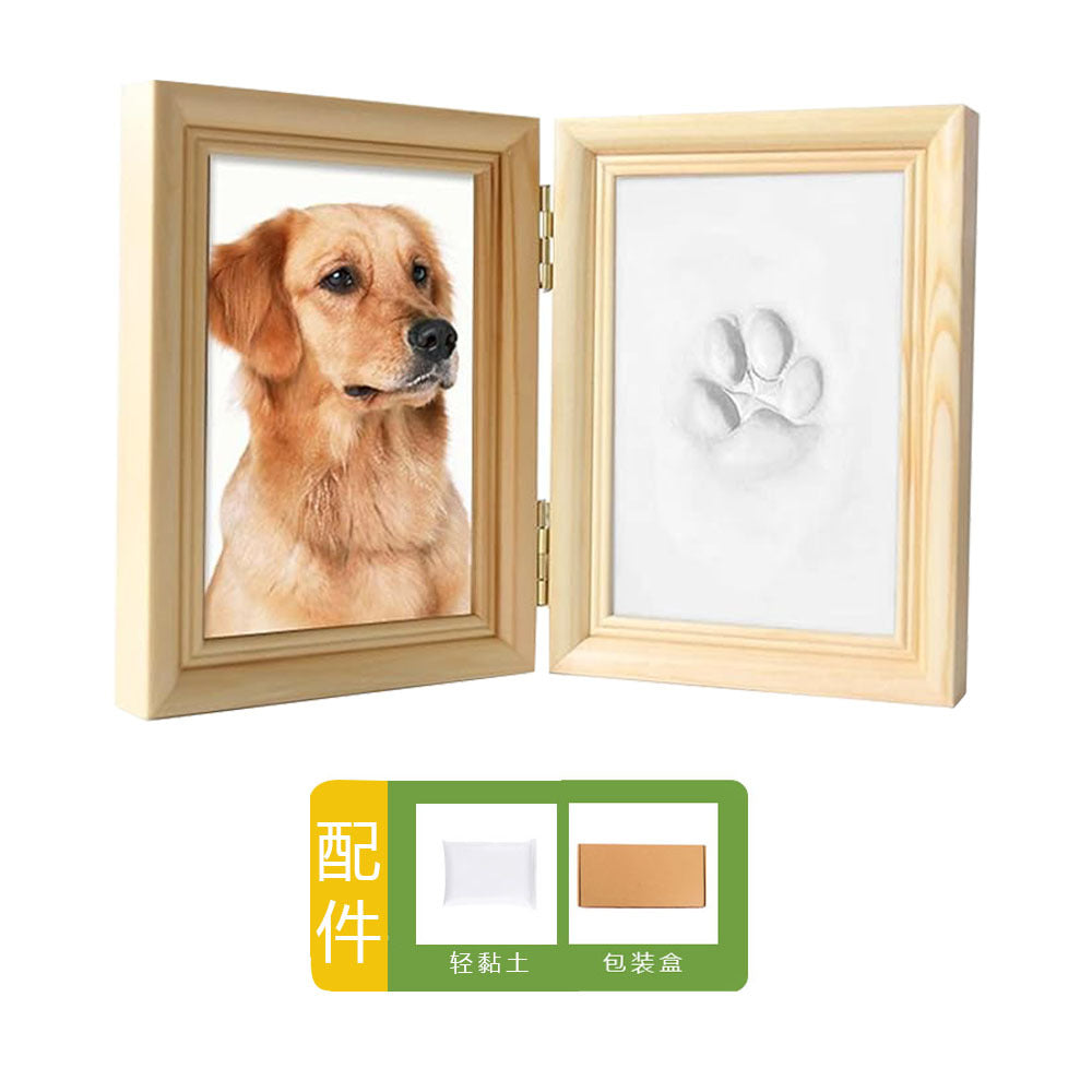 DIY hollow photo frame with baby's 100-day and first birthday hand and footprints, pet paw prints, and baby hand and footprint clay keepsakes.