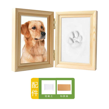 DIY hollow photo frame with baby's 100-day and first birthday hand and footprints, pet paw prints, and baby hand and footprint clay keepsakes.