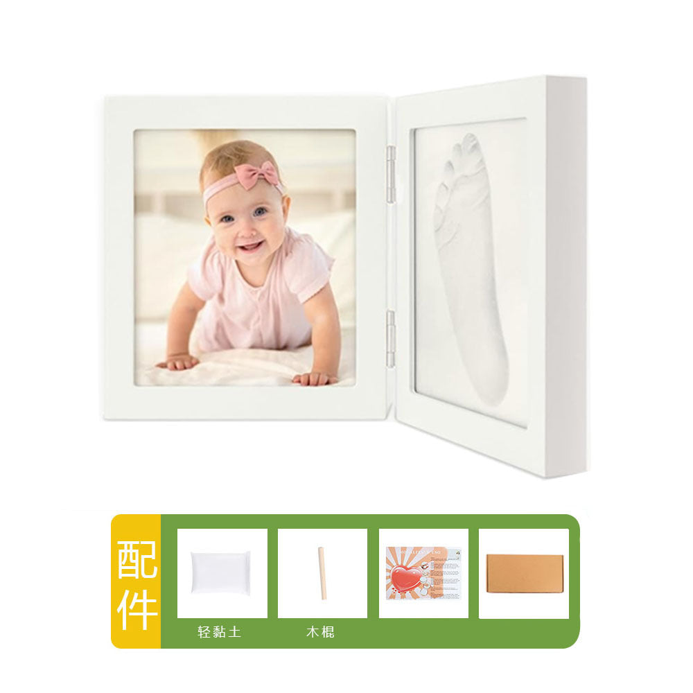 DIY hollow photo frame with baby's 100-day and first birthday hand and footprints, pet paw prints, and baby hand and footprint clay keepsakes.