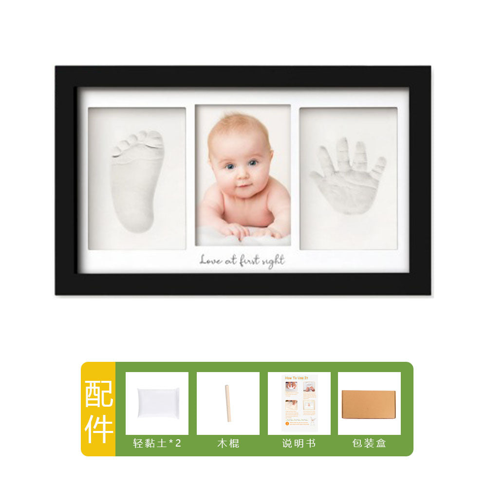 DIY hollow photo frame with baby's 100-day and first birthday hand and footprints, pet paw prints, and baby hand and footprint clay keepsakes.