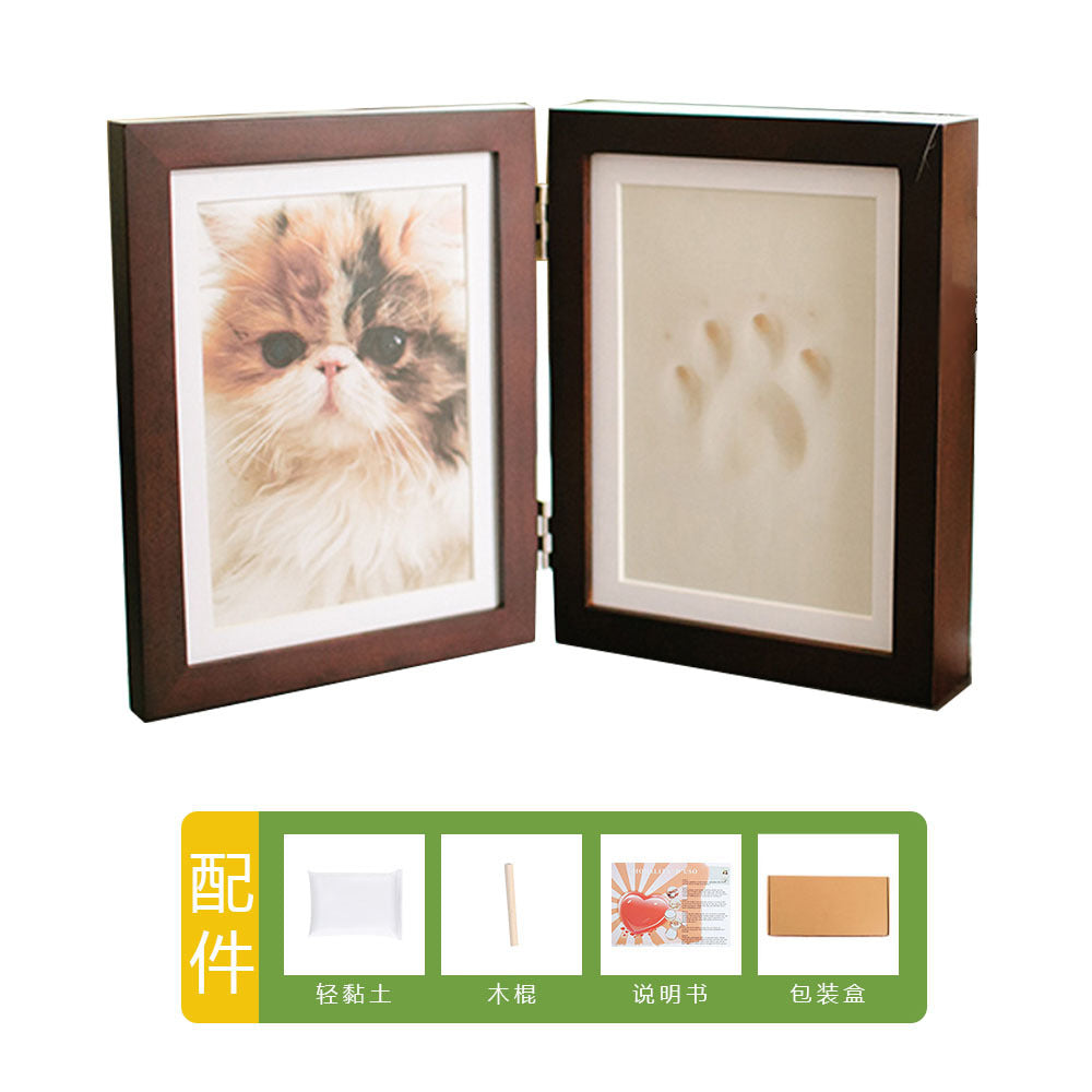 DIY hollow photo frame with baby's 100-day and first birthday hand and footprints, pet paw prints, and baby hand and footprint clay keepsakes.
