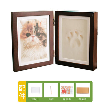 DIY hollow photo frame with baby's 100-day and first birthday hand and footprints, pet paw prints, and baby hand and footprint clay keepsakes.