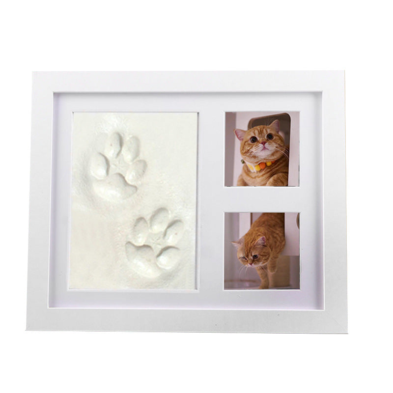 DIY hollow photo frame with baby's 100-day and first birthday hand and footprints, pet paw prints, and baby hand and footprint clay keepsakes.
