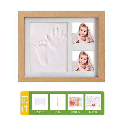 DIY hollow photo frame with baby's 100-day and first birthday hand and footprints, pet paw prints, and baby hand and footprint clay keepsakes.