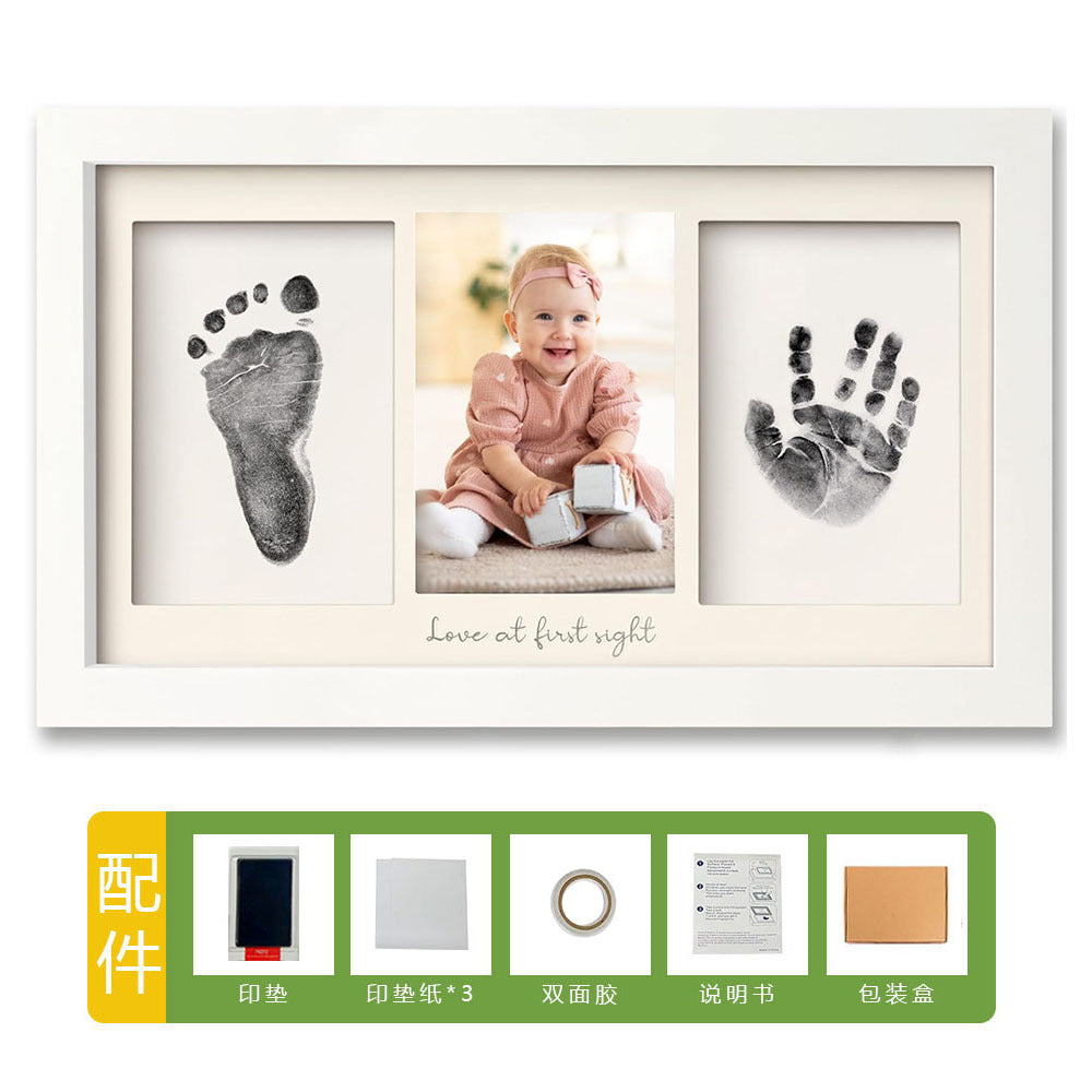 DIY hollow photo frame with baby's 100-day and first birthday hand and footprints, pet paw prints, and baby hand and footprint clay keepsakes.
